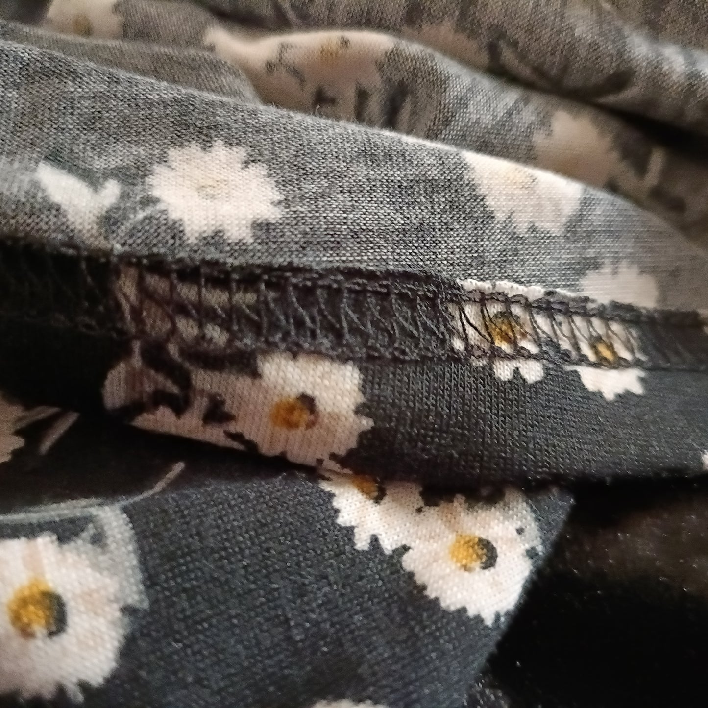 Black Daisy Print Asymmetrical Top with Lace Shoulder Strap and Neckline