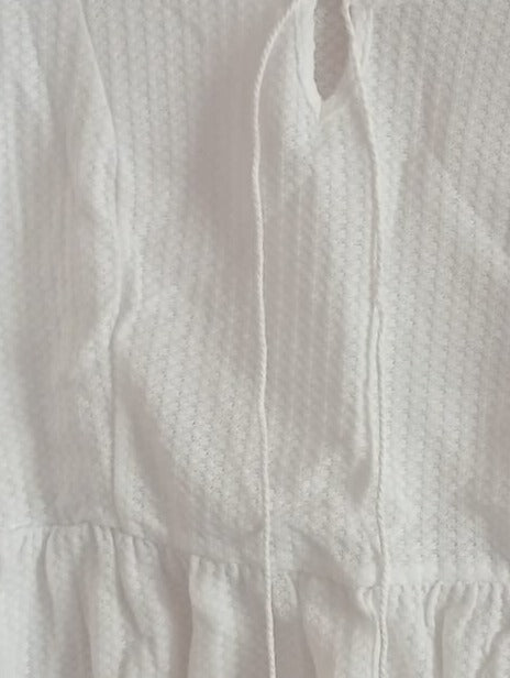 Cream Peplum Top with Tassel Tie Front Neckline
