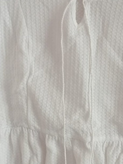 Cream Peplum Top with Tassel Tie Front Neckline